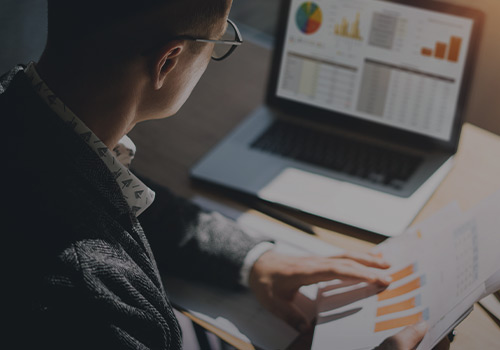 Man looking at analytics on laptop