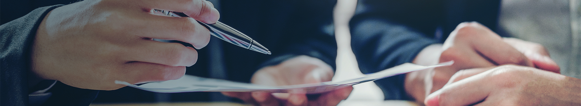 Businessman Holding a Pen to a Paper