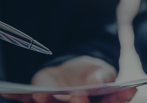 Businessman Holding a Pen to a Paper