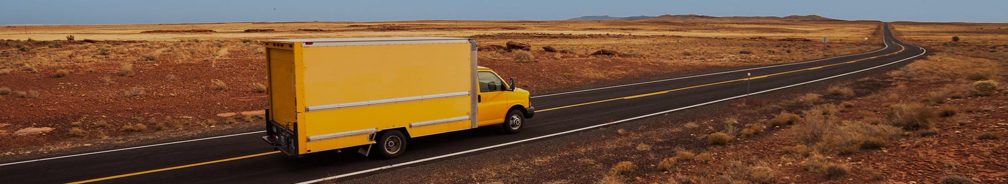 Yellow Moving Truck on Highway