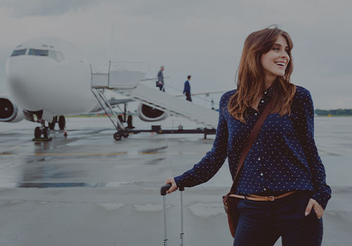 Person Traveling with Plane Behind Them