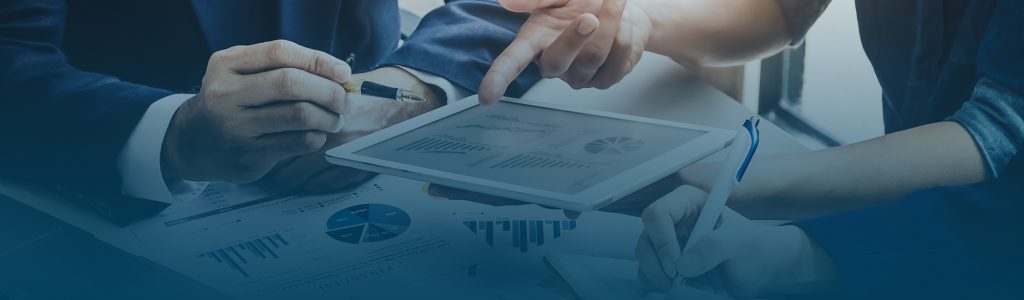 Person pointing to tablet with analytics on it