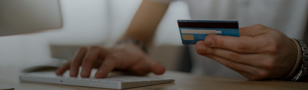 Person Shopping Online with Credit Card in Hand