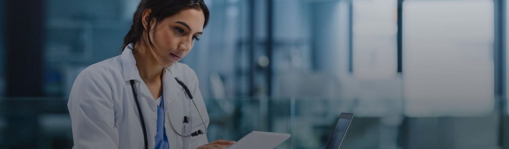 Doctor Reviewing Patient Info on Tablet