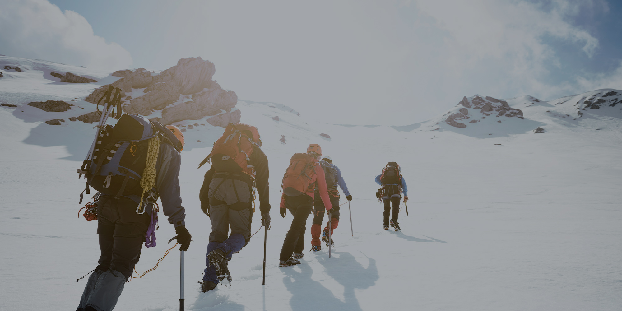 Hikers Climbing Up Snowy Mountain