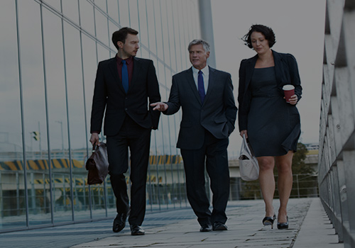 Three Business People Walking Outside