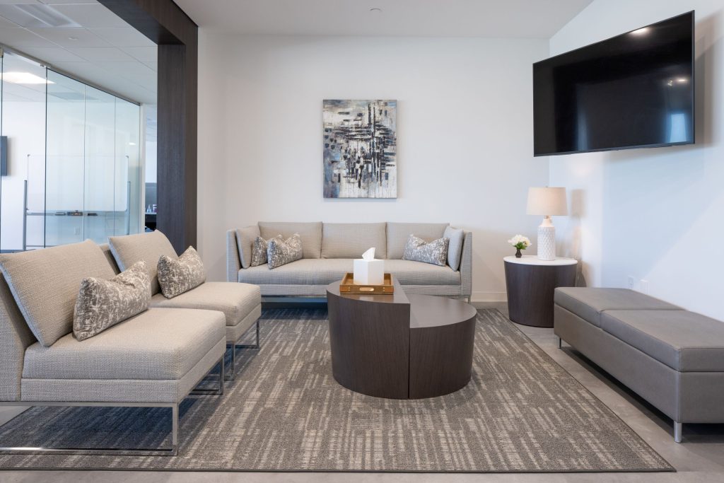 office lobby waiting area with seating and TV mounted high on wall