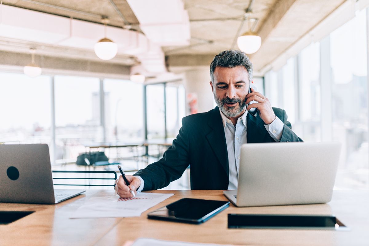 Businessman at the office talking on cell phone