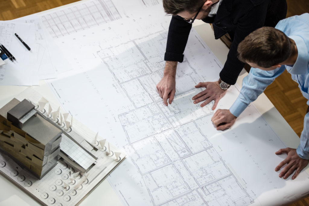 Architect explaining blueprint to client