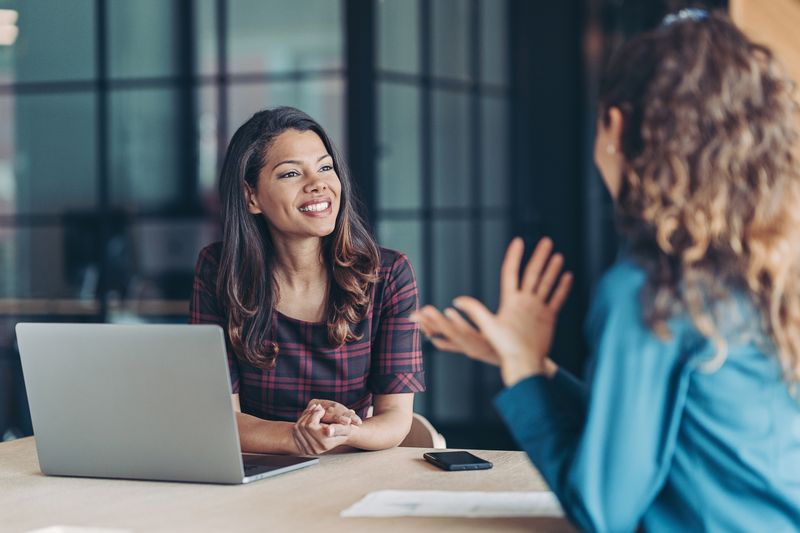 Two women conversation at work.