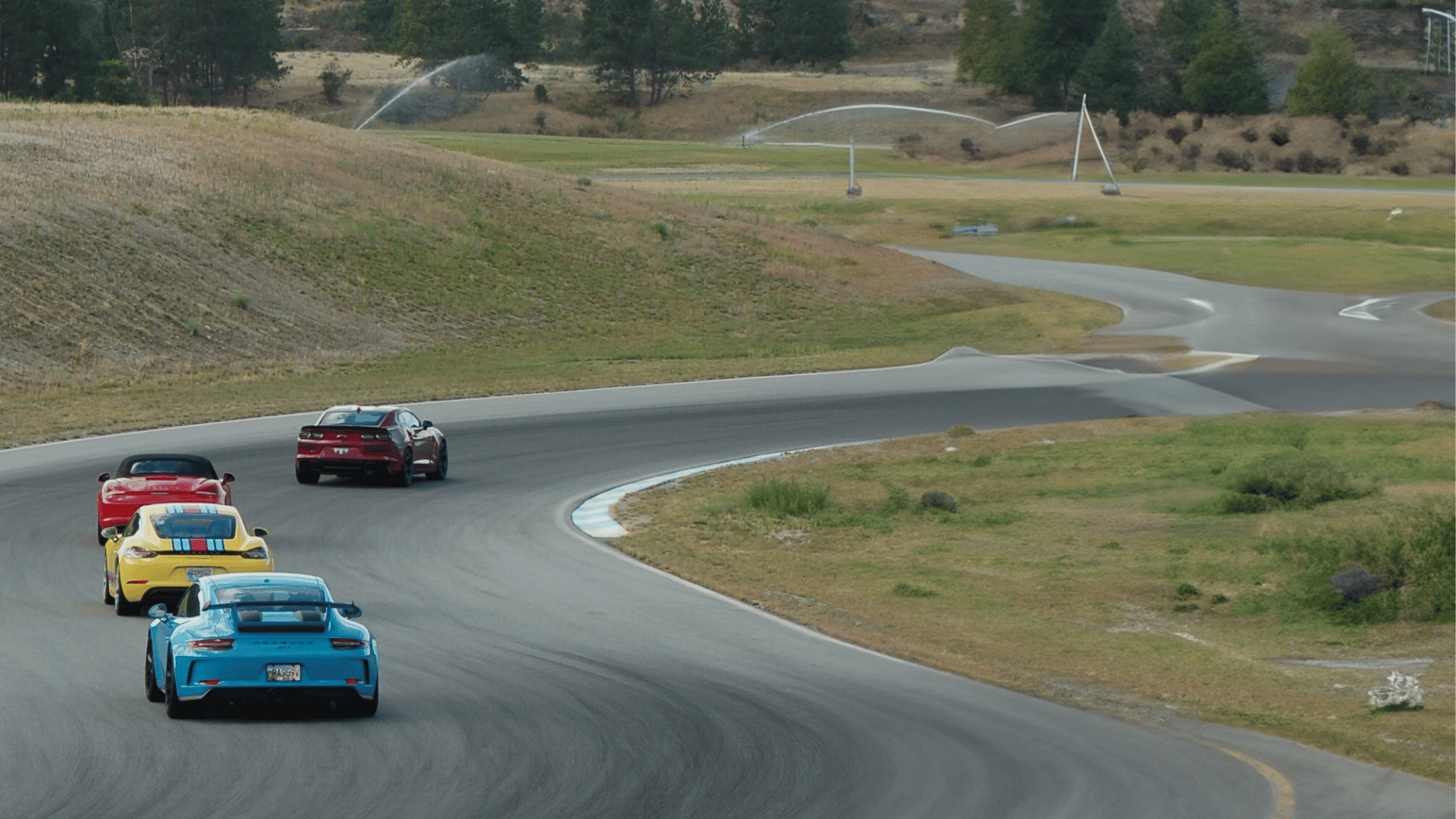 4 sportscars on a race track