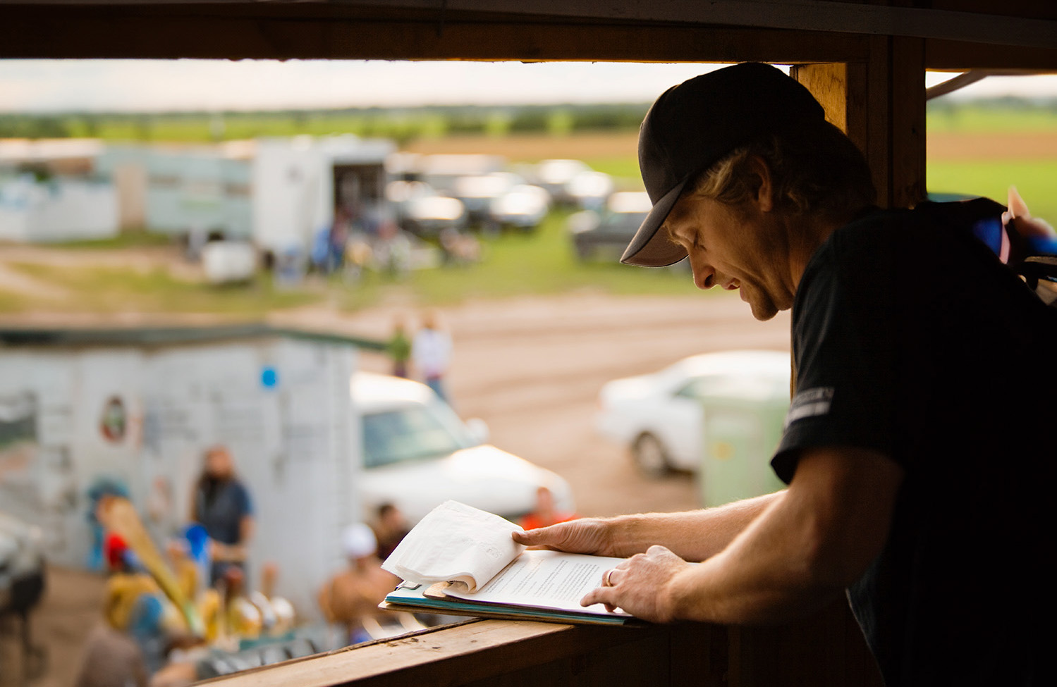 Man in hat looking at clipboard