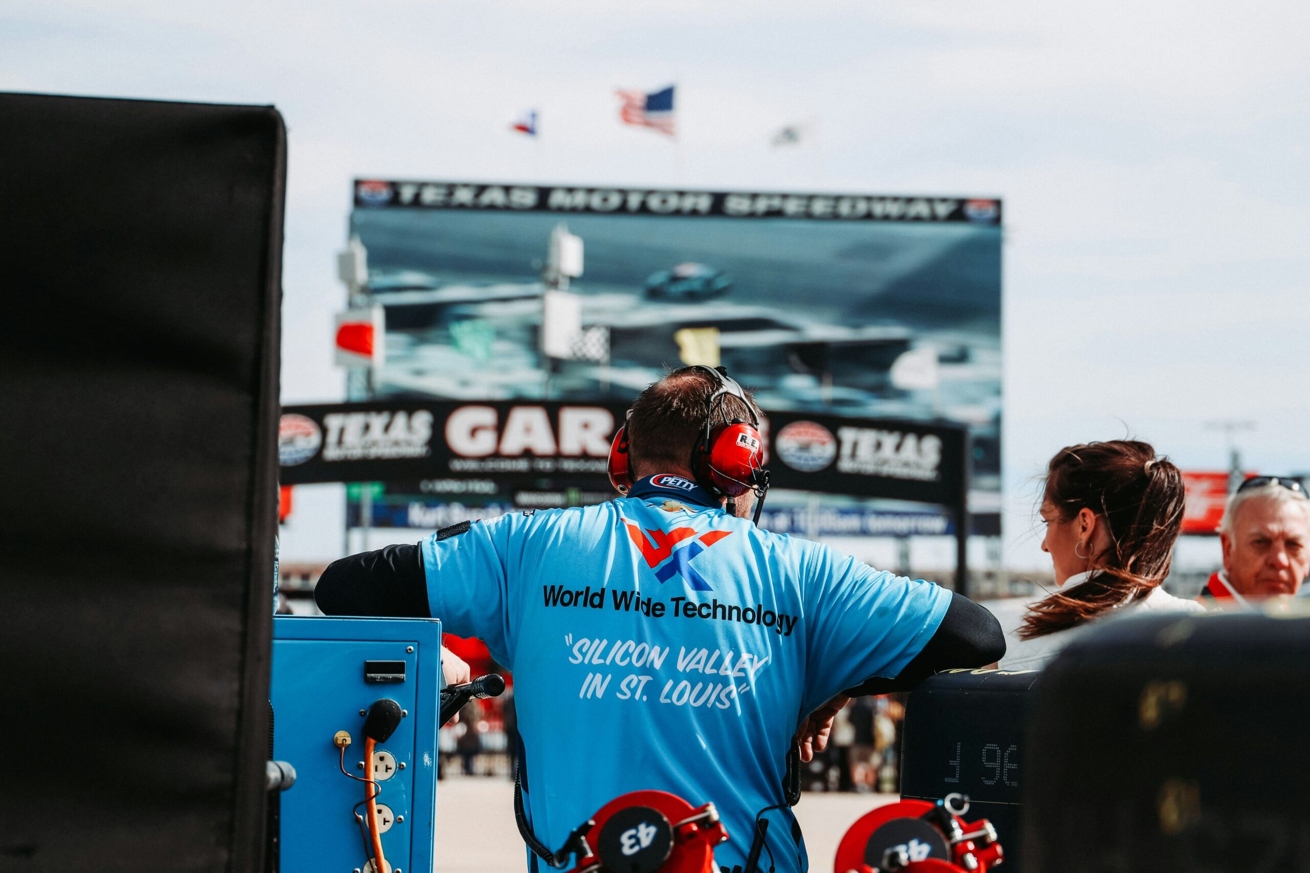 Man wearing ear covering at race track