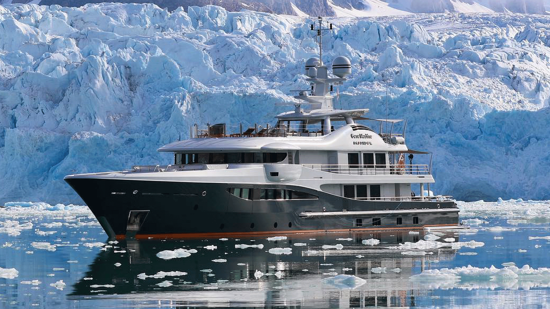 yacht in water near iceberg