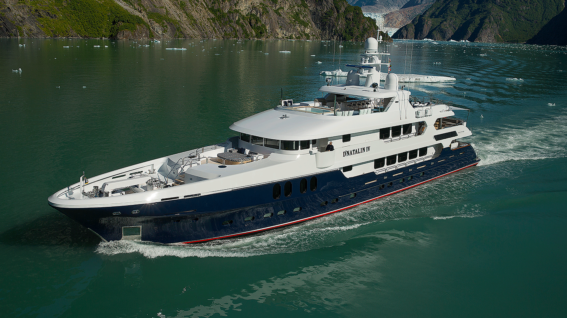 yacht sailing in water near mountains