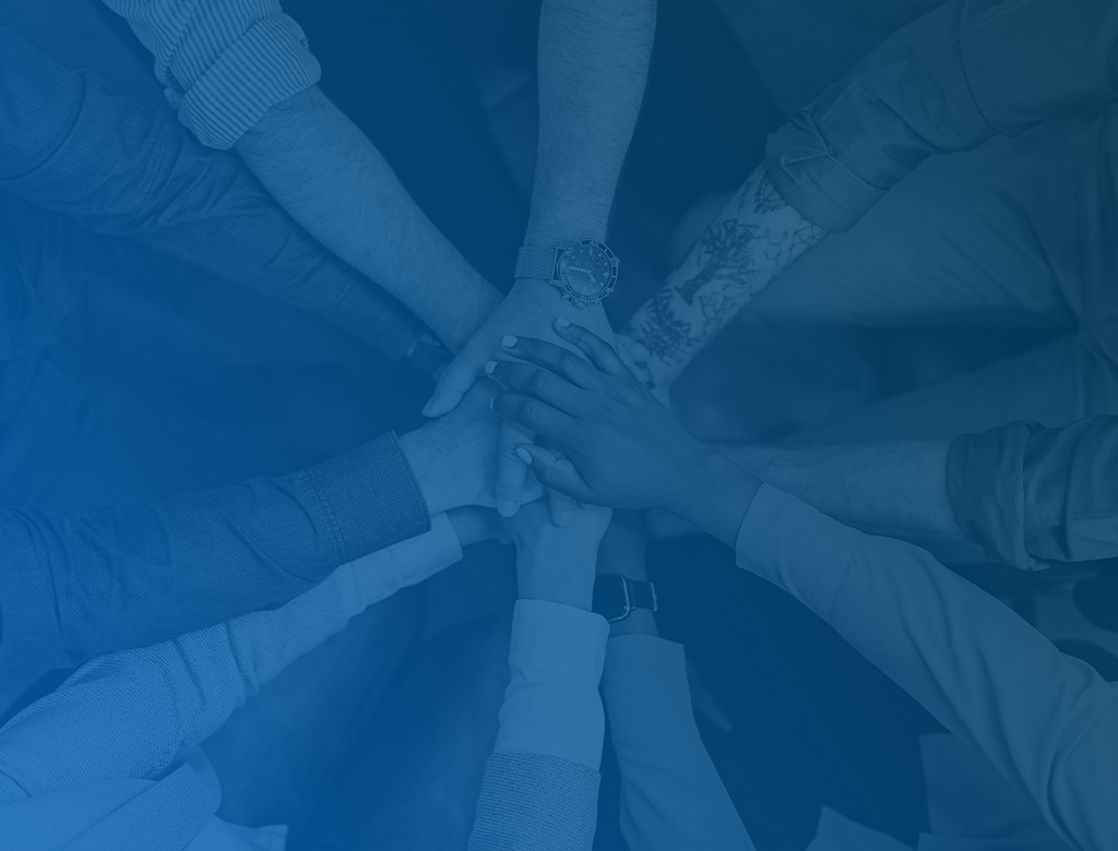 diverse set of hands stacked in team building activity