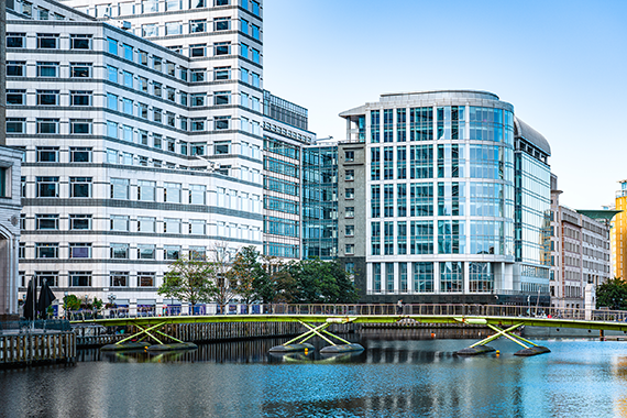 business buildings near river and bridge