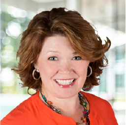 Headshot of Lisa Malloy, a smiling fair-skinned woman with short hair