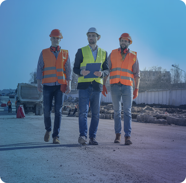 three construction workers in protective gear walking