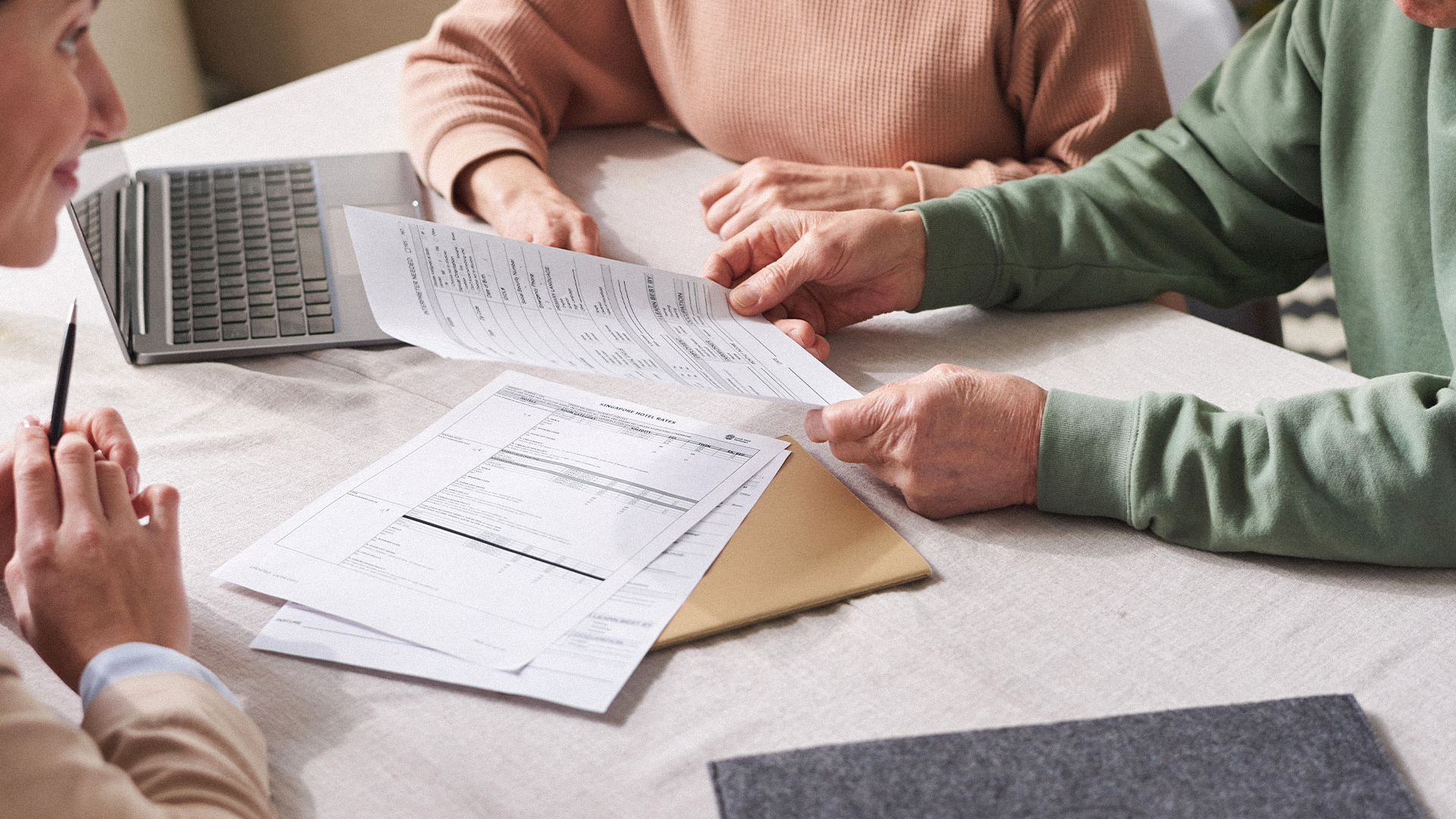 people reviewing paper documents