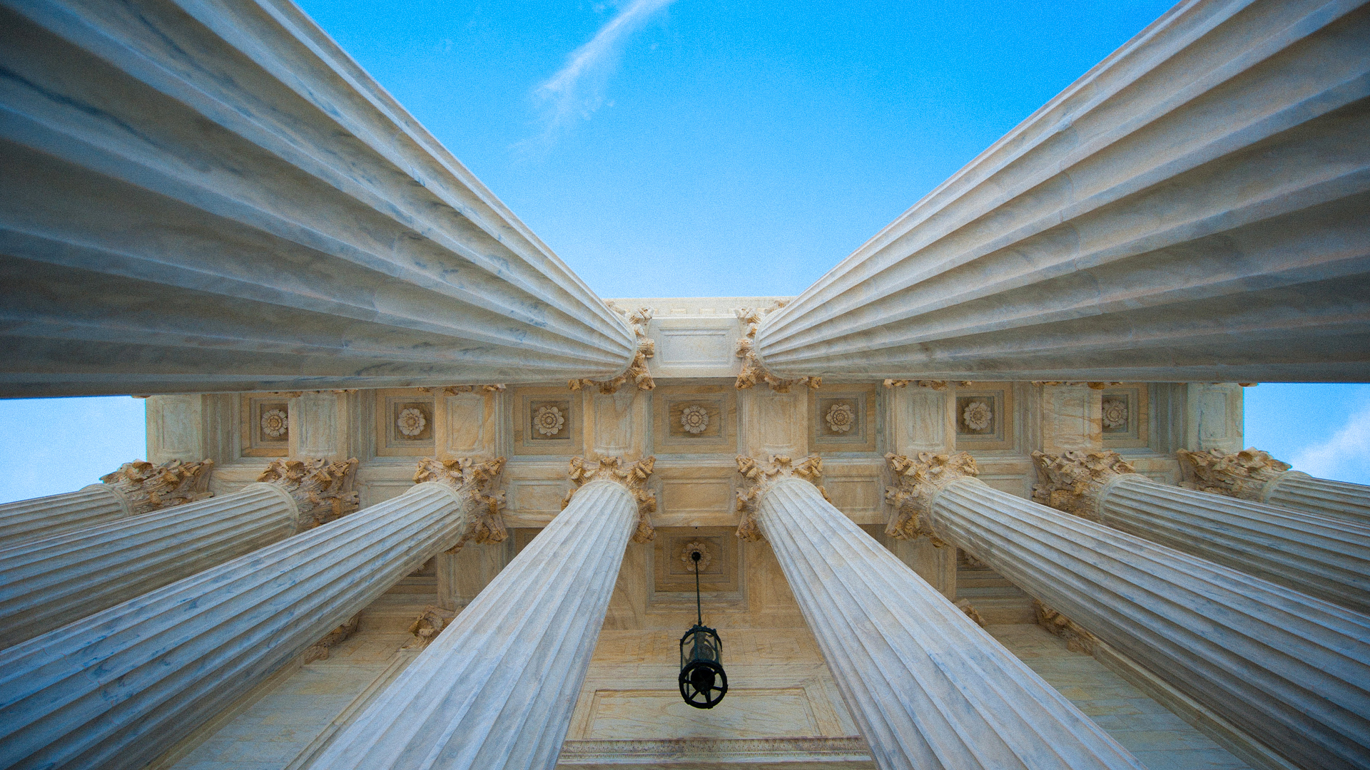 looking up at ceiling between marble columns