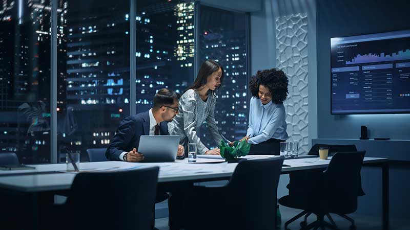 business professionals working in office at night